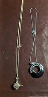 Both necklaces laid flat showing full length and pendants