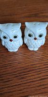 two white ceramic owl salt and pepper shakers front view
