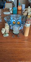 Group shot of three owl decor pieces and Christmas bowl