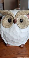 Front view of white carved-look owl sculpture
