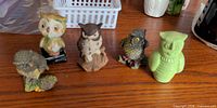 All six owl figurines arranged on tabletop