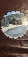 Full view of painted saw blade showing entire winter mill scene