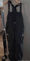 Full view of FXR black bib pants hanging