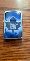 Front view of closed Zippo lighter showing Toronto Maple Leafs graphic