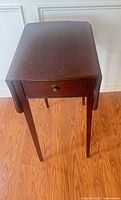 Side table with leaves lowered showing drawer and legs