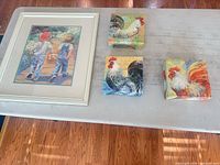 Overall view of framed children print and three rooster canvas blocks on table
