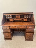 Front view of oak roll-top desk closed