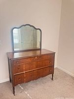 Front view of dresser with attached scalloped mirror