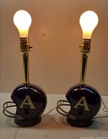 Both lamps lit to show working condition, helmet bases visible
