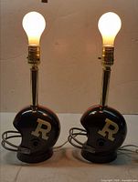 Pair of helmet lamps lit with bulbs installed