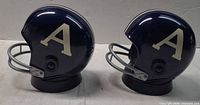 Two navy blue helmet radios side view with cream 'A'