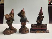 Front view of three Tom Clark gnome figurines