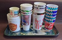 Tray laying flat with three stacks of assorted plastic cups