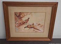 Full view of framed pheasant artwork showing frame, mat and glass