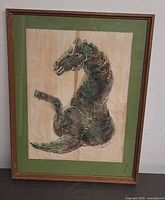 Full view of framed horse artwork with green mat