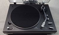 Full view of JVC JL-F45 turntable with dustcover open showing platter, tonearm, controls and attached cables