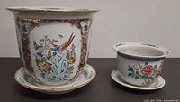 side view of both cachepots on saucers