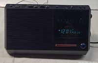 Front view showing speaker grille, digital display, controls