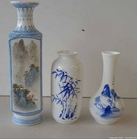 Front view of three porcelain vases showing designs and shapes