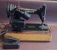 Side view of Singer 99K sewing machine on base with motor and foot pedal