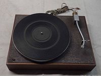 Top view showing full turntable, platter, mat, tonearm and power cord