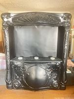 Full view of black cast iron fireplace insert