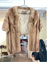 Front view of mink stole on hanger