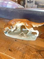 Full left-side view of porcelain Irish Setter figurine on base