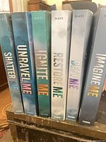 Spine view of all six Shatter Me series books