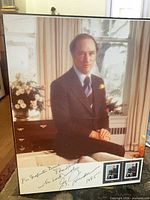 Front view of signed Trudeau portrait with stamps