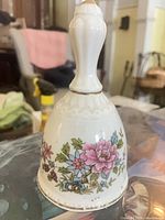 Overall view of Paragon bone china bell showing floral design and gold trim