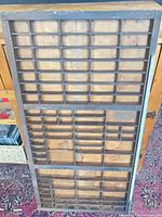 Full view front of wooden printers tray showing compartment grid