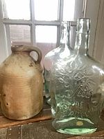 Stoneware jug with two ‘Jus de Fruits’ bottles grouped