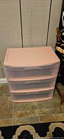 Front view of pink plastic 3-drawer organizer showing overall condition