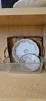 Plate, bowl, glass dish, wicker basket on shelf