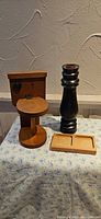 Overall view of three wooden items: toilet paper holder, candlestick, tray