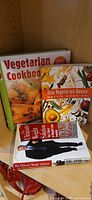 Three books stacked: Vegetarian Cookbook, New Vegetarian Basics, The Ultimate Weight Solution