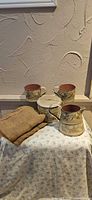 Full view of all tinware pieces and burlap cloth displayed together