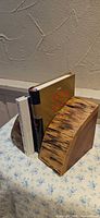 Pair of wood bookends holding two hardcover books