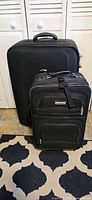 Two black Sonoma suitcases upright on floor