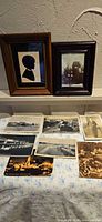 Front view of two framed photographs and seven loose postcards