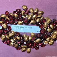 Loose oval fuchsia rhinestones with identifying label