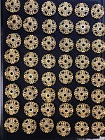 Grid of bead caps on black backing showing full quantity and uniform design