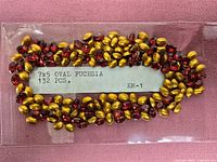 Front view of rhinestones on card showing label and mix of red faces and gold backs