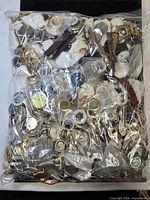 Entire sealed plastic bag containing mixed watch parts