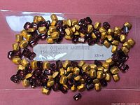 Bag of purple octagon rhinestones showing gold backs and label with size and quantity