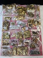 Overall view of multiple bags of metal findings and beads