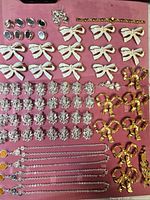 overall view of sorted jewelry components on pink board