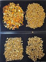 Four piles of assorted gold-tone findings on black surface