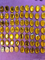 Grid of oval gold topaz flat-back acrylic rhinestones